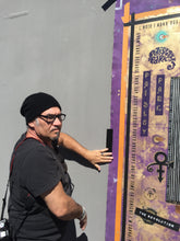Marco points toward a large purple and gold mixed-media art painting of Prince featuring the text Paisley Park