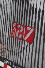 Close-up of a silver glittery surface with vertical black stripes, a red square containing the word 'CLUB' in white, and large red '27' numerals, with partial text 'i don't know' visible at the bottom.