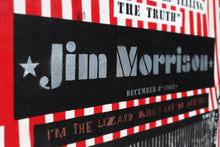 A close-up of a Jim Morrison poster or print featuring a black central panel with silver text reading 'Jim Morrison' and 'December 3 1943', surrounded by red-and-white striped borders and additional text including 'I'm the lizard king i can do anything'.