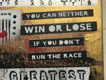 Close-up of a textured mixed-media art print featuring motivational quotes in white text on black rectangular banners over a distressed gold, red, and black background.