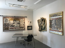 At the Bruce Lurie art gallery showing a large Muhammad Ali  tapestry on the left wall, a sculptural draped textile hanging in the center, and David Bowie tribute on the right wall.