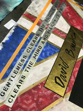 A close-up of a mixed-media art Painting featuring a British flag design with gold foil accents, text reading 'GENTLENESS CLEANS THE MIND AND MAKES IT FREE' on white strips, and a gold panel with the name 'David Bowie' in black script.