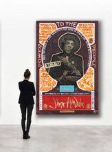 A person in a black blazer and pants stands facing a large framed Jim Morrison 'To The People' poster in a minimalist white gallery setting.