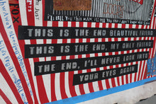A close-up of a distressed, red and white striped wall with black text panels reading 'THIS IS THE END BEAUTIFUL FRIEND' and other dark text, alongside blue handwritten text on the left.