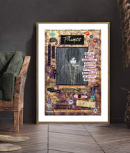 A framed art print of Prince featuring a portrait with 'Prince' written at the top, displayed leaning against a dark wall in a styled interior setting.